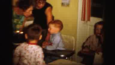 Lynbrook New York (1971): Mother Lights Candles On Birthday Cake And Lets Child