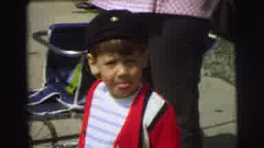 Lynbrook New York (1973): Boy Standing Near Stroller With His Tongue Out Watching