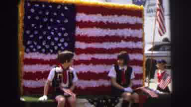 Lynbrook New York (1973): Two Girls Ride On An American Flag Parade Float On A