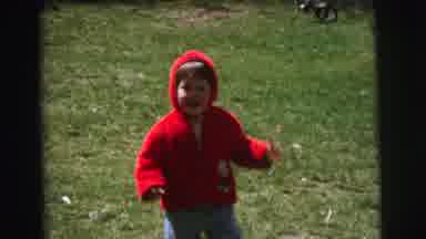 Lynbrook New York (1973): Child In Red Jacket And Hood Run Across The Lawn Towards
