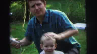 Lynbrook New York (1973): Man Gives Haircut To Young Boy While Another Boy