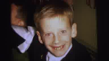 Lynbrook New York (1973): A Funny Boy In Suite Is Laughing At The Camera With