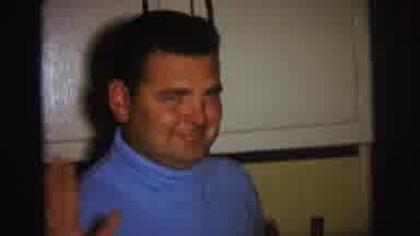 Lynbrook New York (1973): Man Wearing Blue Shirt Smiles And Waves At Camera While