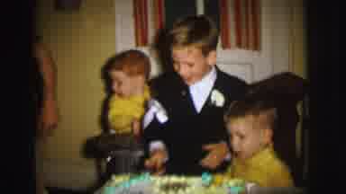 Lynbrook New York (1973): Boy Cuts A Birthday Cake Next To His Brothers And Mother