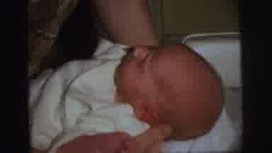 Lynbrook New York (1973): Newborn Baby Being Dressed In White Clothes By Parent