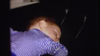 Lynbrook New York (1973): Child Wearing Blue Pajamas Sleeps On A Black Chair