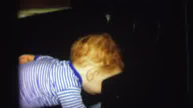 Lynbrook New York (1973): Red Haired Child Laughing And Playing On The Floor While