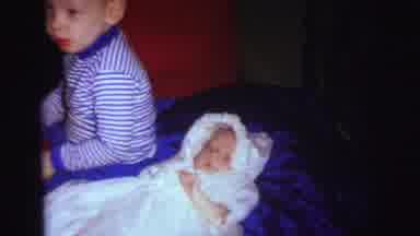Lynbrook New York (1973): Boy Wearing Blue Shirt Sits Next To Baby Wearing White