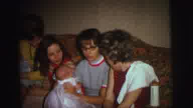 Lynbrook New York (1973): Woman Wearing Brown Shirt Brushes Boy's Hair With Hand