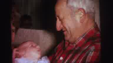 Lynbrook New York (1973): Older Gentleman Happily And Carefully Holds An Infant