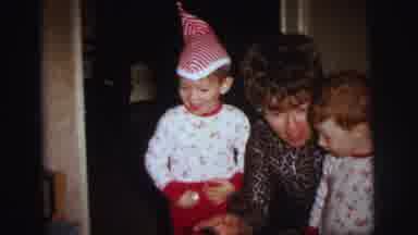 LYNBROOK NEW YORK-1973: Mother Kisses Son On The Cheek With Elf Hat Boy