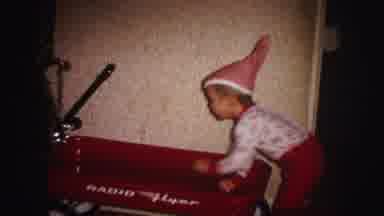 Lynbrook New York (1973): Young Boy Wearing Red Christmas Pajamas Climbing Into