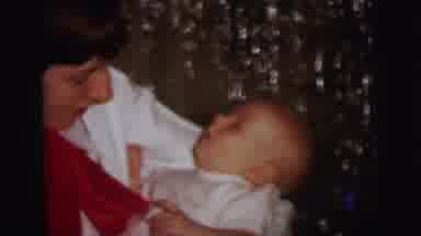 Lynbrook New York (1973): A Woman Is Standing Inside The House With A Baby In Her