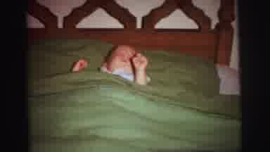 Lynbrook New York (1973): Baby Laying In Bed Wiggling Around And Kid In Purple