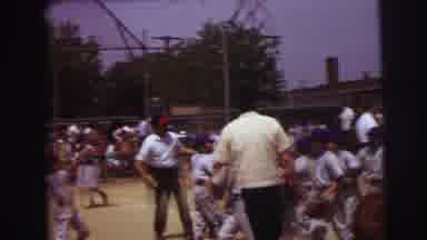 Lynbrook New York (1973): Baby Sucks On Thumb While Baseball Players Rush Off