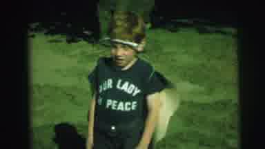 Lynbrook New York (1973): A Boy Sticks A Sticker Like A Butterfly On His Back Body