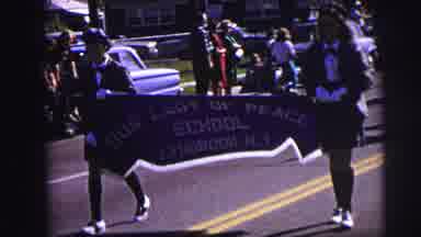 Lynbrook New York (1973): Two Girls Carry School Parade Banner In Front Of