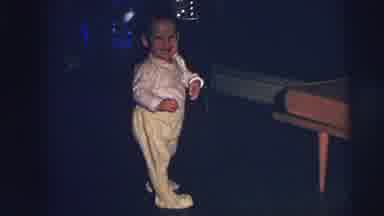 Lynbrook New York (1973): A Happy Baby Teethers On His Legs Near A Display Of Blue