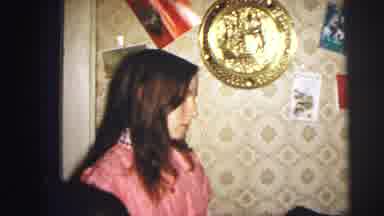 Lynbrook New York (1973): Girl Wearing Pink Nightgown Decorates Red Fireplace