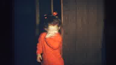 Lynbrook New York (1973): Happy Girl In Red Dress And Ribbon Hair Tie Nibbles Her