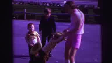 Lynbrook New York-1973: Girl Wearing Pink Shorts Swings Boy Wearing Yellow Striped Shirt