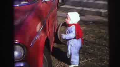 Lynbrook New York (1973): Toddler Wearing Blue Snowsuit Walks To Red Car On A