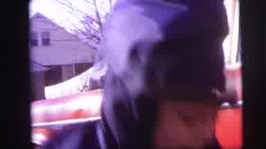 Lynbrook New York (1973): Child In Winter Clothing Helps A Smaller Child Up From