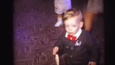 Lynbrook New York (1973): Boy Wearing Brown Suit With Red Tie Holds Small Tan