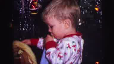 Lynbrook New York-1973: Toddler Sucking On Bottle Near Christmas Present