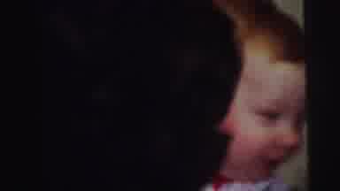 Lynbrook New York (1973): Woman Wearing Red Dress Carries Baby To Inflated Clown