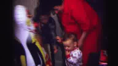 Lynbrook New York (1973): Child Accompanied By His Mother Plays With Inflatable