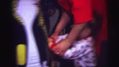 Lynbrook New York (1973): Woman In A Red Dress Helping A Little Toddler Punch A