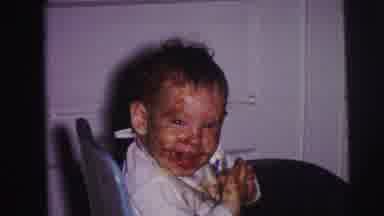 Lynbrook New York (1973): A Smiling Baby With Food On Its Face And A Young Child