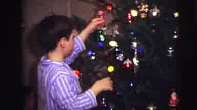 Lynbrook New York (1973): Boy In Blue Striped Pajamas Decorating A Tree While A
