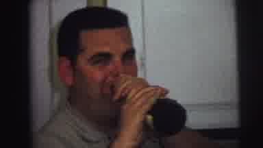 Lynbrook New York (1973): A Young Boy And A Man Pretending To Take A Drink From A
