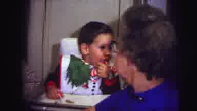 Lynbrook New York (1973): Toddler Boy Seated In Highchair With Christmas Bib