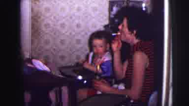 Lynbrook New York (1973): Adult Smoking A Cigarette In Front Of Child Sitting In A