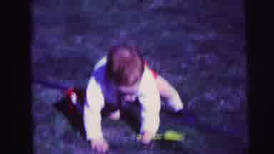 Lynbrook New York-1973: 1960's Toddler Playing Outdoors With Shovel And Bucket