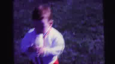 Lynbrook New York-1973: Toddler Playing With Bucket In Backyard