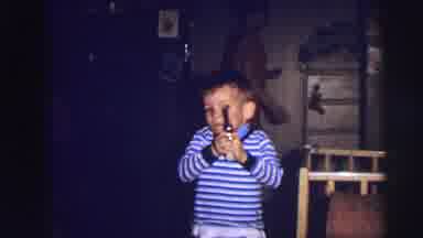 Lynbrook New York (1973): Boy Wearing Blue Shirt Watches Another Boy Play With Toy