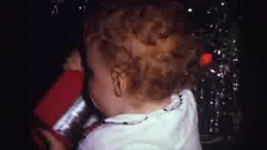 Lynbrook New York (1973): Young Child With Red Curly Hair Picking Up A Christmas