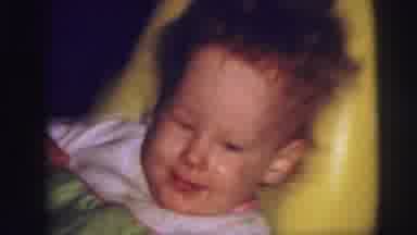 Lynbrook New York (1973): Happy Baby Kicks Legs Back Rocking Yellow Plastic Chair