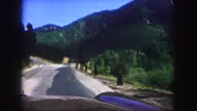 Colorado Springs USA (1958): A Car Driving Along A Road Out In The Wilderness Then