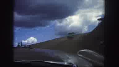 Colorado Springs USA (1958): Car Closely Following Another Car Along Dirt Road