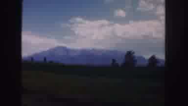 Colorado-1958: Driving By Mountains And Grassy Hills Under The Blue Sky Filled