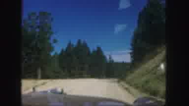 Colorado (1958): Passing View Of Green Trees And Mountains On A Clear Day