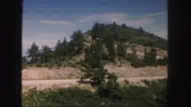 Colorado (1958): Grassy Hill With Some Trees Next To Road In Old Footage