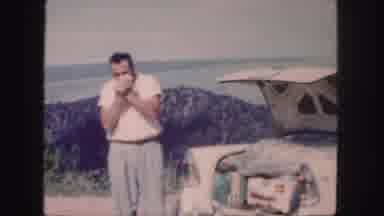 Colorado (1958): Man And Woman Smoking On The Beach Outside Their Car