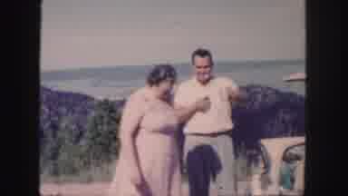 Colorado (1958): Woman Wearing Pink Dress Looks At Mountain On A Bright Sunny Day