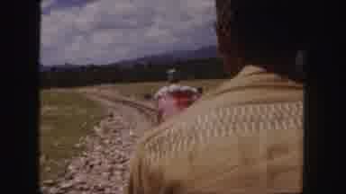 Colorado (1958): Miniature Red Train Traveling In A Scenic Area With Mountains And